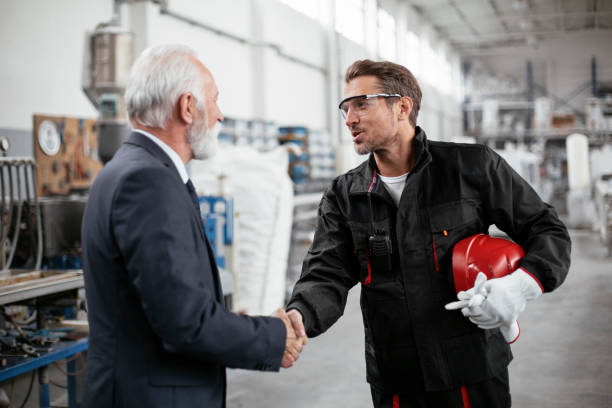 istock Arhitect and worker handshake in factory. 1271694662