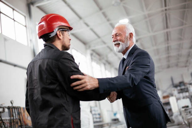 istock Arhitect and worker handshake in factory. 1271694718