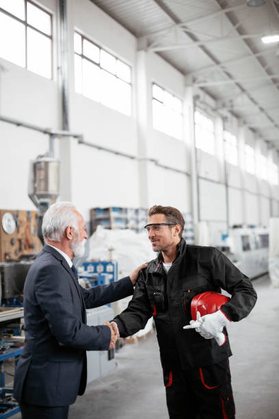 istock Arhitect and worker handshake in factory. 1271694719