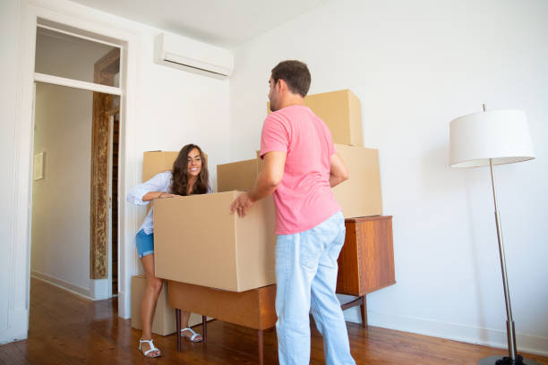 istock Happy young Hispanic couple moving into new flat 1271694794