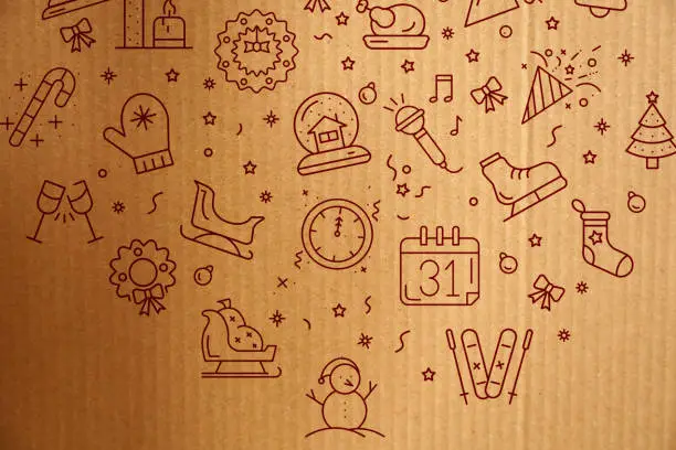 Photo of New year shopping concept. New year icons on cardboard box.