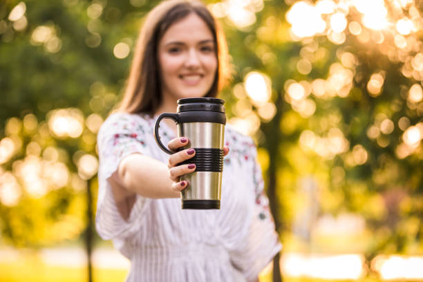istock Young woman enjoying coffee in a reusable mug 1271696236