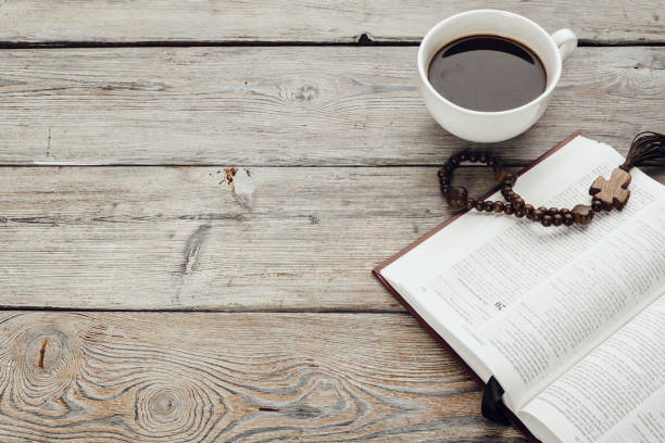 istock Bible and a crucifix on an old wooden table. Religion concept. 1271696355