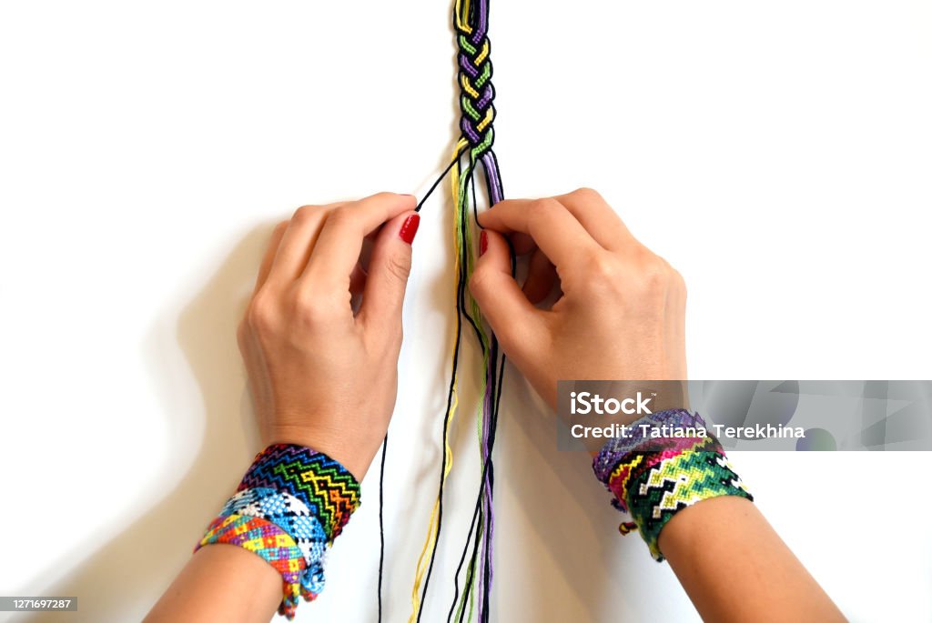 Process Of Weaving Knot For Diy Friendship Bracelet Pigtail Female Hands  With Many Handmade Bracelets On Wrists Step By Step White Background With  Copy Space Stock Photo - Download Image Now - iStock