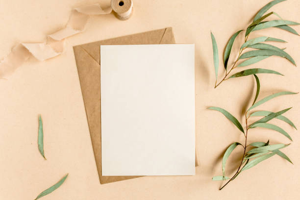 istock Mockup invitation, blank greeting card and craft envelope, green leaves eucalyptus. Flat lay, top view 1271701066