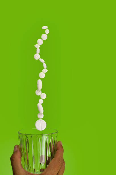 istock group of white pills suspended on drinking glass 1271701216