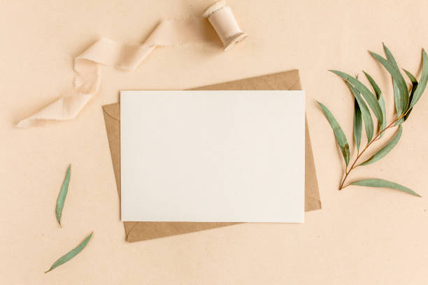istock Mockup invitation, blank greeting card and craft envelope, green leaves eucalyptus. Flat lay, top view 1271701359