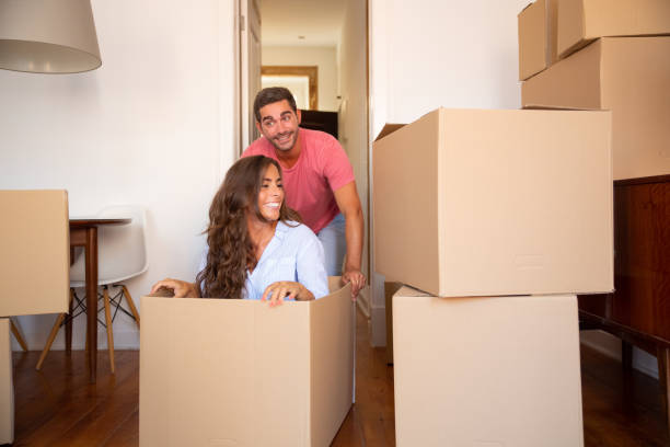 istock Joyful family couple having fun while moving into new flat 1271702535