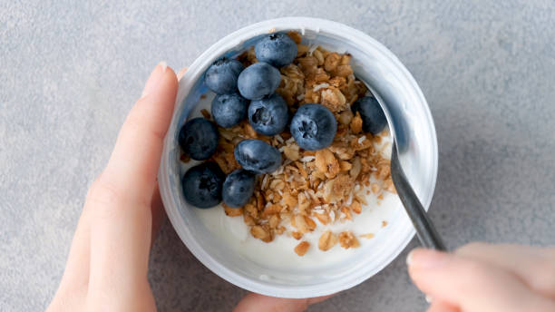 istock Eating yogurt with granola and blueberries 1271702634