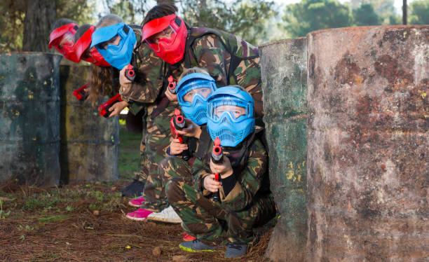 istock Group of nice kids playing paintball 1271703568