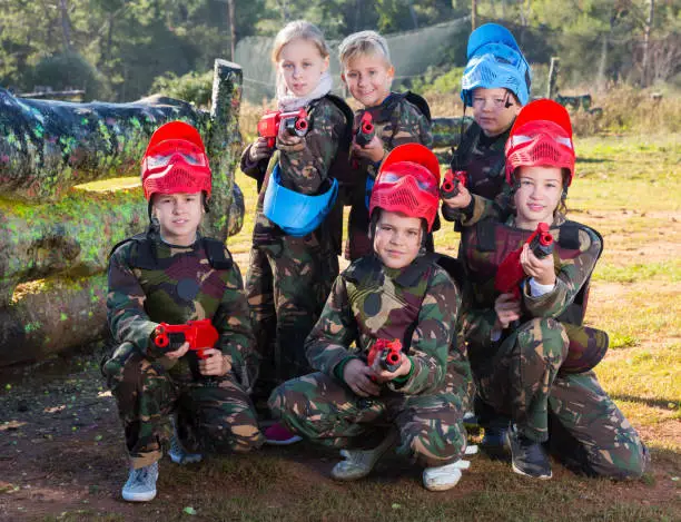 Photo of kids paintball players ready for playing outdoor