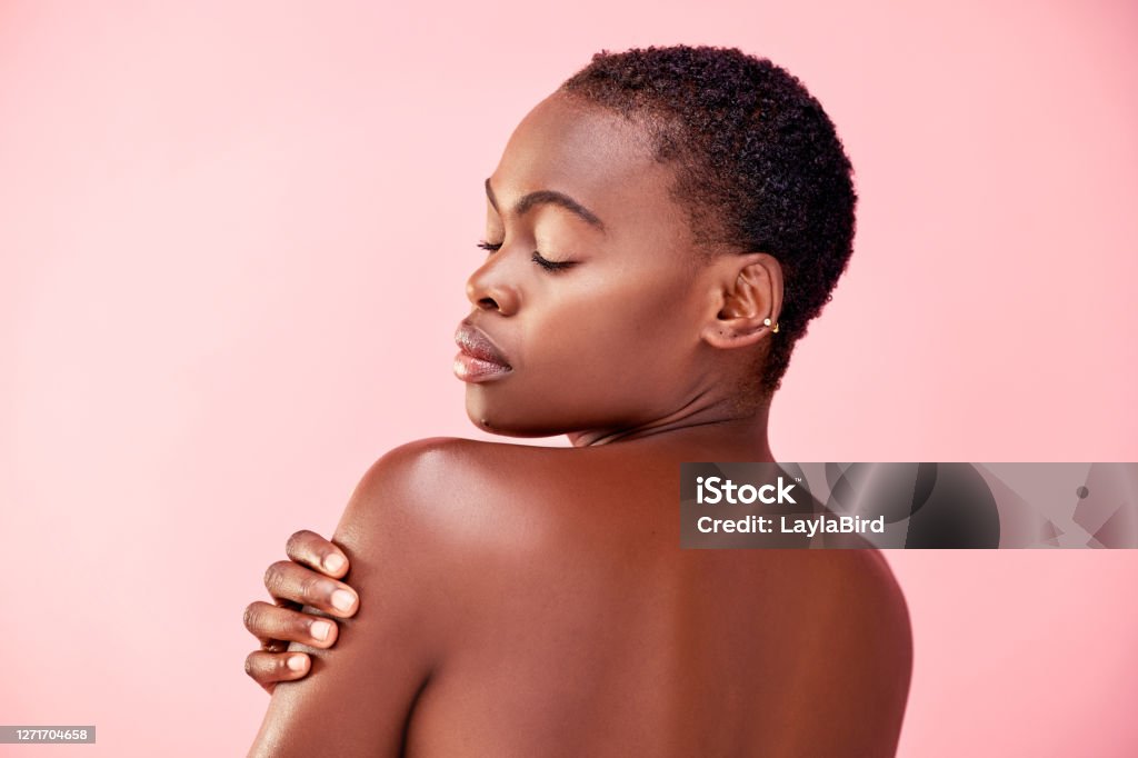 Perfect, just the way she is Studio shot of a beautiful young woman posing against a pink background Women Stock Photo