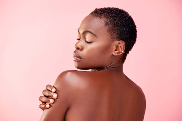 Perfect, just the way she is Studio shot of a beautiful young woman posing against a pink background beautiful black woman stock pictures, royalty-free photos & images