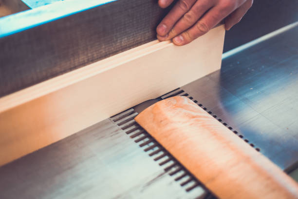 Carpenter engaged in processing wood at the sawmill. Carpenter engaged in processing wood at the sawmill. sawmill gravy stock pictures, royalty-free photos & images