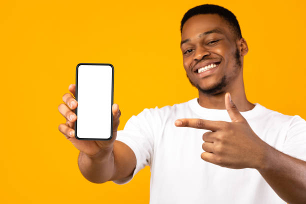istock African American Man Showing Mobile Phone Screen, Yellow Background, Mockup 1271707351