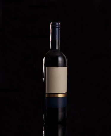 the contour of the bottle is outlined by light. glass photo on black background