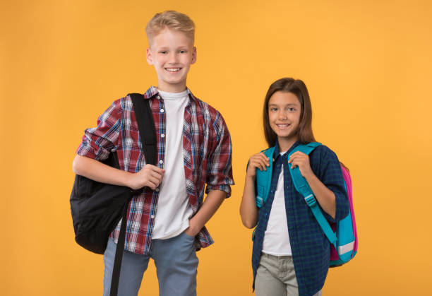 istock Schoolchildren posing with schoolbags at studio background 1271708134