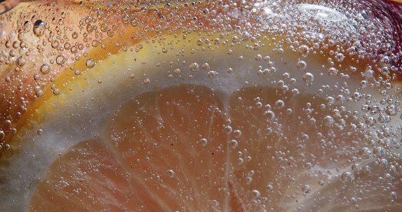 Lemon slice in soda water. Extreme close-up
