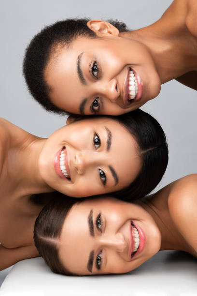 istock Three Diverse Girls Posing Together Smiling On Gray Background, Vertical 1271709044
