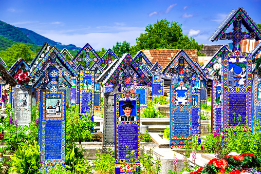 Sapanta, Romania - June 2016:  Joy Cemetery (Cimitirul Vesel) in Maramures county, famous colourful tombstones paintings.