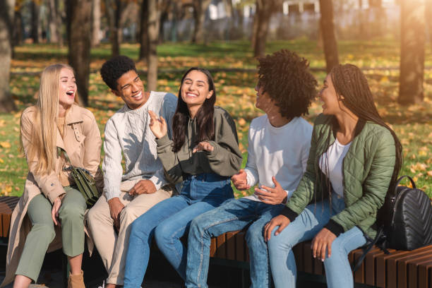 istock Teenagers having fun in public park, talking and laughing 1271709211