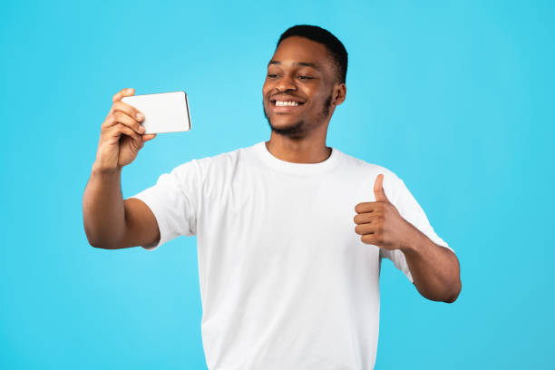 istock African American Man Making Selfie Gesturing Thumbs-Up Over Blue Background 1271709268