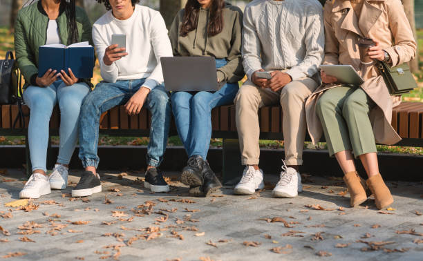 istock Friends spending time in park, studying, using cellphones 1271710120