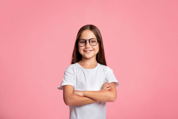 Smart Kid. Cheerful Little Child In Glasses With Crossed Arms
