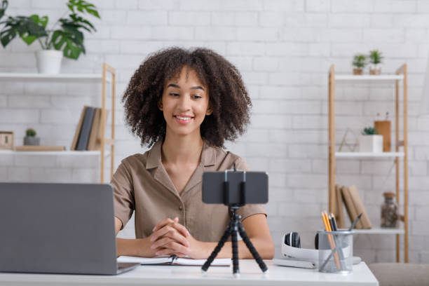 istock African american woman student looking at computer, watching webinar or doing video chat by webcam 1271711595