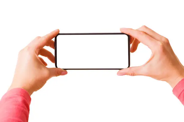Person holding in hands smartphone with blank screen and taking picture or recording video, photo isolated on white background