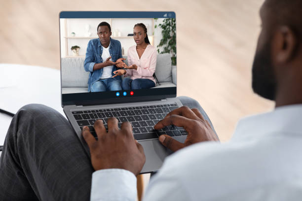 Marriage Therapist Consulting Black Couple Via Web Conference Online On Laptop Marriage Therapist Consulting Black Couple Via Web Conference Online On Laptop, Over Shoulder View, Selective Focus premarital online counseling stock pictures, royalty-free photos & images