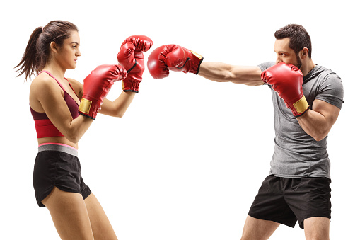 Man and woman boxing with red gloves isolated on white background