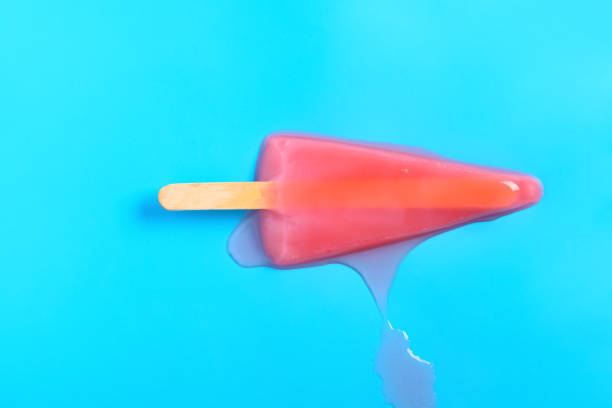 istock top view watermelon slice shape and flavor popsicle in a melting process on a blue background 1271713610