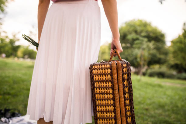 istock Carrying a wicker squared basket and finding a picnic spot 1271714577