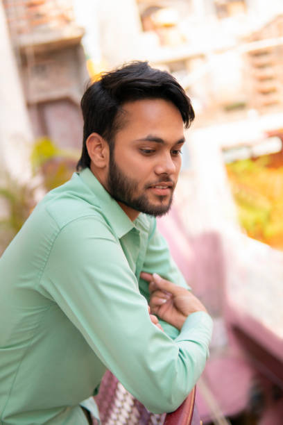 istock Indian young man standing in balcony and thinking. 1271714977