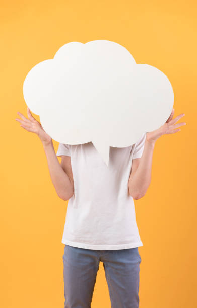 istock Teenage guy holding blank white speech bubble 1271715721