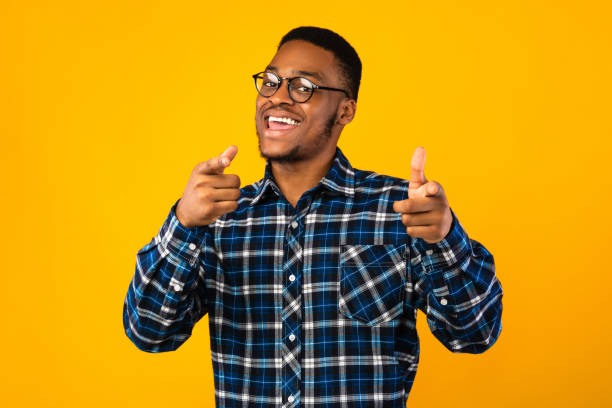 istock African Guy Pointing Fingers At Camera On Yellow Background, Studio 1271715793