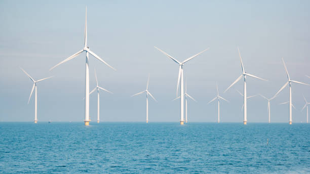 istock offshore windmill park with stormy clouds and a blue sky, windmill park in the ocean 1271718863