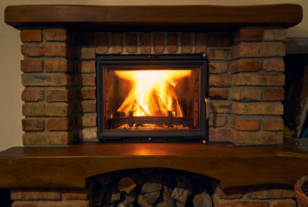 istock fireplace and fire close view as object or background, brick wall 1271718874