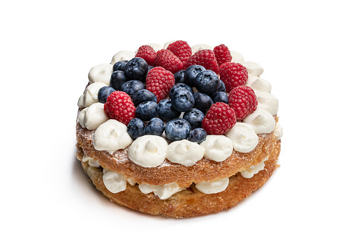Victoria  sponge cake with whipped cream and berries on top isolated on white