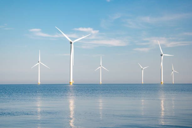 istock offshore windmill park with stormy clouds and a blue sky, windmill park in the ocean 1271719480