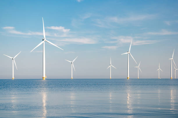 istock offshore windmill park with stormy clouds and a blue sky, windmill park in the ocean 1271720253