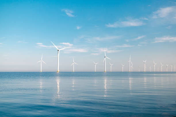 istock offshore windmill park with stormy clouds and a blue sky, windmill park in the ocean 1271720349