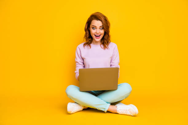 istock Full size photo astonished girl sit floor legs folded crossed work computer read information watch video call communicate with friends wear good look pullover isolated shine color background 1271722369