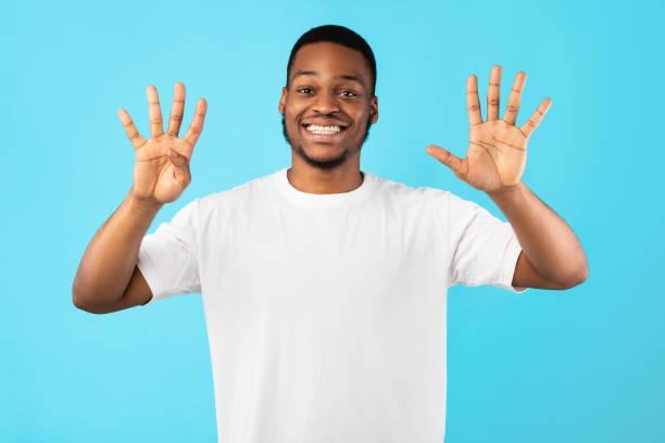 istock African Man Counting Showing Number Nine Standing In Studio 1271723491