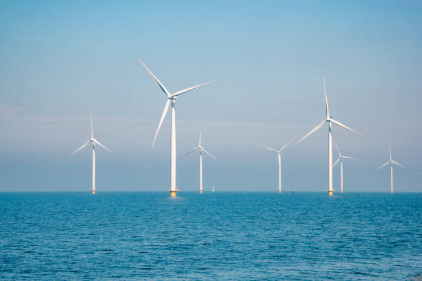 istock offshore windmill park with stormy clouds and a blue sky, windmill park in the ocean 1271724249