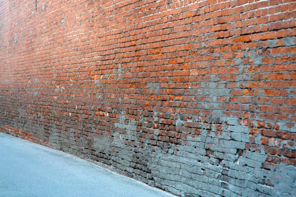 istock Old brick wall. Brickwork from an old brick in a rustic style. The structure and pattern of the destroyed stone wall. Copy space. 1271724324
