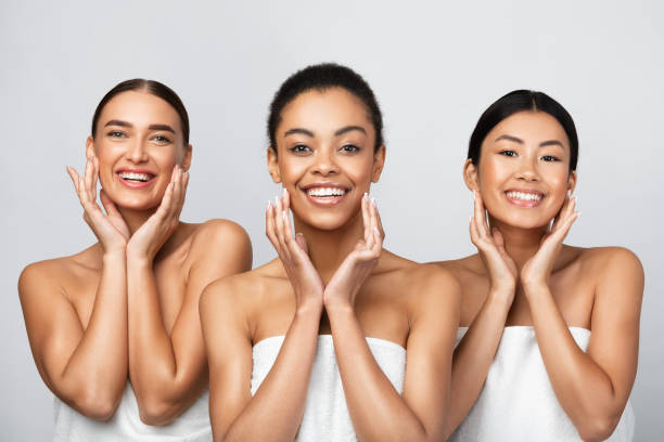 istock Three Women Touching Face Caring For Skin On Gray Background 1271725092