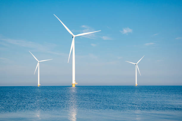 istock offshore windmill park with stormy clouds and a blue sky, windmill park in the ocean 1271726540