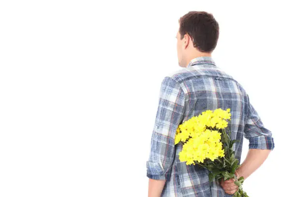 Photo of Mothers day. Handsome man with yellow bouquet of flowers isolated on white. Copy space and mock up